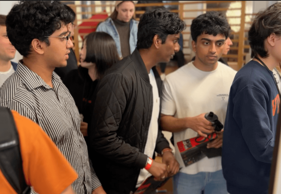 Aurelius Robotics team members working together with their competition robot.